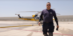 Joe Martinez poses in front of an LA County Fire Department helicopter.
